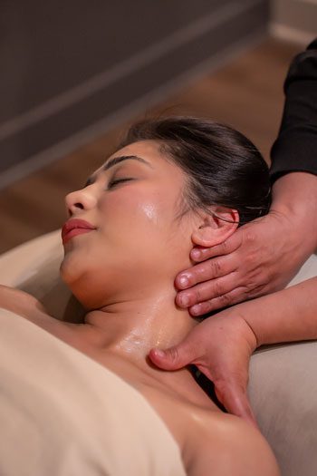 swedish-massag A therapist perfoming a heart stone massage on a client.