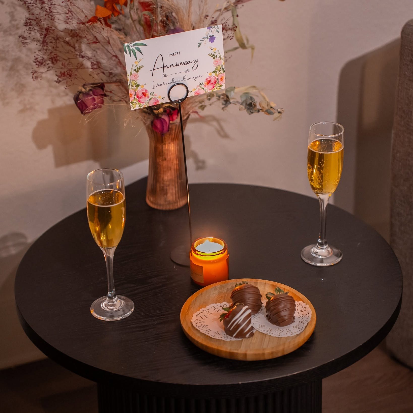 Champagne, chocolate-covered strawberries and an anniversary card prepared in a Zen'd Out suite